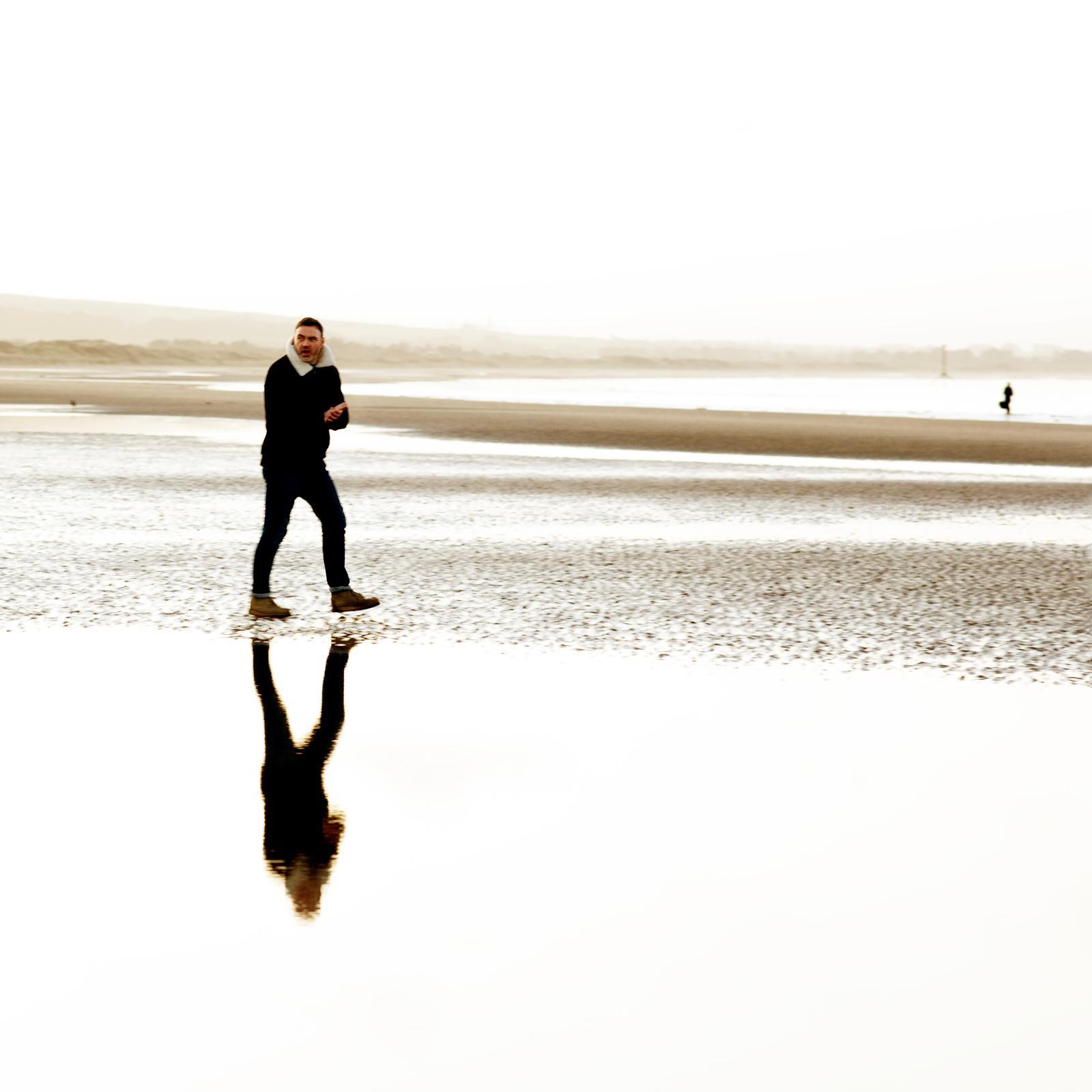 David standing in silhouette against sun